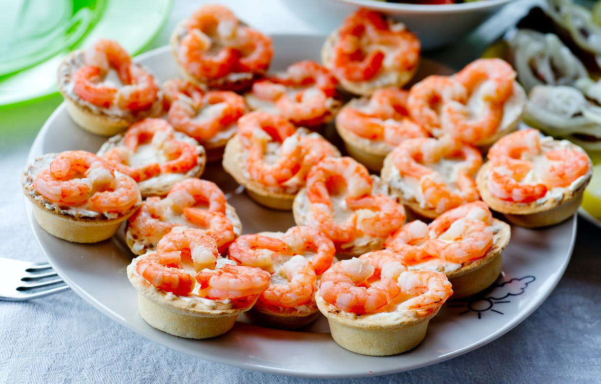 Cheese loaded shrimp tarts served on a plate