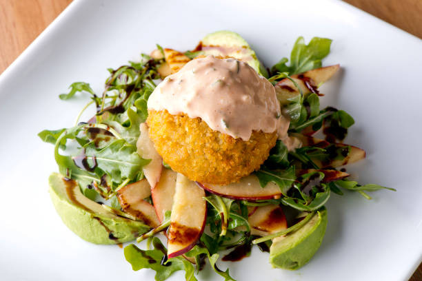 Crab cakes served with sauce and salad