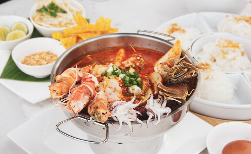 Mixed seafood assortment presented in a pot with sides